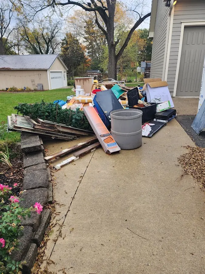 Dumpster being loaded with debris for Residential Dumpster Rental in Princeton